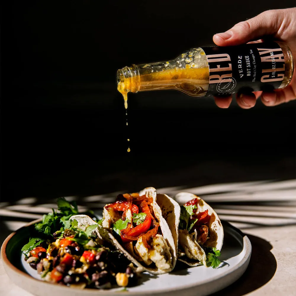 Verde Hot Sauce & Marinade poured over tacos