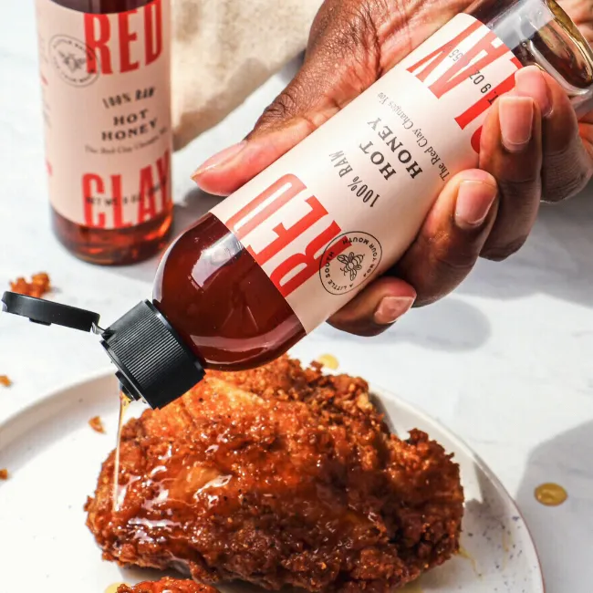 Red Clay hot sauce poured over fried chicken