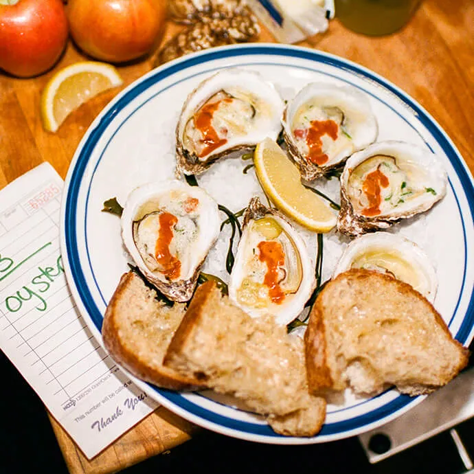 A platter of oysters with lemon and Red Clay hot sauce